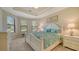 Spacious main bedroom with a large bed, bay windows, and a tray ceiling at 12667 Sorrento Way, Bradenton, FL 34211