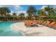 Large community pool with plenty of lounge chairs and surrounding landscaping at 12667 Sorrento Way, Bradenton, FL 34211