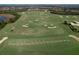 Aerial view of community golf course with sand traps and putting green at 15407 Castle Park Ter, Lakewood Ranch, FL 34202