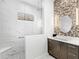 Spa-like bathroom with a walk-in shower, marble tile, and modern vanity at 15407 Castle Park Ter, Lakewood Ranch, FL 34202