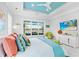 Main bedroom with large window, teal accents, and a flat-screen TV at 15407 Castle Park Ter, Lakewood Ranch, FL 34202