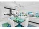 Modern kitchen with white cabinets, a large island, and a view into the dining area at 15407 Castle Park Ter, Lakewood Ranch, FL 34202
