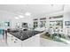 Spacious kitchen with a large island featuring a black marble countertop at 15407 Castle Park Ter, Lakewood Ranch, FL 34202