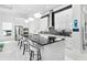 Modern kitchen with white cabinets, black countertops, and stainless steel appliances at 15407 Castle Park Ter, Lakewood Ranch, FL 34202