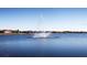 Tranquil lake with a water fountain in a residential community at 15407 Castle Park Ter, Lakewood Ranch, FL 34202