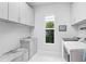 Bright laundry room with washer, dryer and storage at 15407 Castle Park Ter, Lakewood Ranch, FL 34202