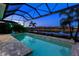 Tranquil night view of a refreshing pool with a covered lanai at 15407 Castle Park Ter, Lakewood Ranch, FL 34202