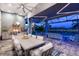 Outdoor kitchen with a built-in grill and dining area, overlooking the pool at 15407 Castle Park Ter, Lakewood Ranch, FL 34202