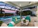 Covered patio with comfortable seating and pool views at 15407 Castle Park Ter, Lakewood Ranch, FL 34202