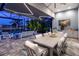 Outdoor dining area with pool and lake views at 15407 Castle Park Ter, Lakewood Ranch, FL 34202
