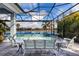 Relaxing pool and patio area with covered lanai overlooking the lake at 15407 Castle Park Ter, Lakewood Ranch, FL 34202