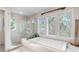 Elegant bathroom with soaking tub, glass-enclosed shower, and large windows at 1656 Hillview St, Sarasota, FL 34239