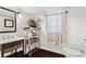 Bathroom featuring dark wood floors, a pedestal sink, and a window with sheer curtains at 1656 Hillview St, Sarasota, FL 34239