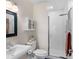 Bright bathroom with white tile shower, pedestal sink, and black-framed mirror at 1656 Hillview St, Sarasota, FL 34239