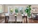 Elegant dining area with a wooden table, large windows, and backyard access at 1656 Hillview St, Sarasota, FL 34239
