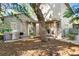 Exterior view of the house with a covered patio, grill, and landscaped yard at 1656 Hillview St, Sarasota, FL 34239
