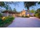 Charming home with a brick driveway, carport, and lush landscaping at dusk at 1656 Hillview St, Sarasota, FL 34239