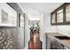 Hallway with decorative wallpaper, leading to a dining area and kitchen at 1656 Hillview St, Sarasota, FL 34239