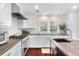 Bright kitchen featuring white cabinetry, stainless steel appliances, and a gas range at 1656 Hillview St, Sarasota, FL 34239
