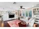 Inviting living room with built-in bookshelves, a ceiling fan, and ample natural light at 1656 Hillview St, Sarasota, FL 34239