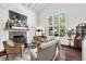 Inviting living room featuring a fireplace, large windows, and comfortable seating at 1656 Hillview St, Sarasota, FL 34239