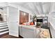 Cozy loft area with white sectional sofa, patterned rug, and built-in shelving at 1656 Hillview St, Sarasota, FL 34239