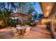 Inviting patio with dining table, umbrella, and lush landscaping, perfect for outdoor gatherings at 1656 Hillview St, Sarasota, FL 34239