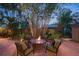 Outdoor patio area with a fire pit, cozy seating, and lush tropical plants at 1656 Hillview St, Sarasota, FL 34239
