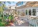 Brick patio with outdoor dining area, surrounded by lush landscaping and trees at 1656 Hillview St, Sarasota, FL 34239