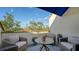Private balcony with outdoor seating and partial water view at 1904 Harbourside Dr # 204, Longboat Key, FL 34228