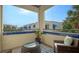 Private balcony with wicker furniture, offering a relaxing outdoor space at 1904 Harbourside Dr # 204, Longboat Key, FL 34228