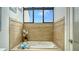 Elegant bathroom featuring a soaking tub and skylight at 1904 Harbourside Dr # 204, Longboat Key, FL 34228