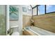 Relaxing bathroom with soaking tub, tile flooring, and skylight at 1904 Harbourside Dr # 204, Longboat Key, FL 34228