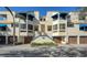 Full view of the building, showcasing architectural details and landscaping at 1904 Harbourside Dr # 204, Longboat Key, FL 34228