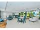 Bright community room with tables and sofas at 1904 Harbourside Dr # 204, Longboat Key, FL 34228
