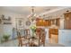 Kitchen and dining area with wooden cabinetry and glass-top table at 1904 Harbourside Dr # 204, Longboat Key, FL 34228