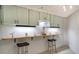 Modern kitchen with light cabinets and a breakfast bar at 1904 Harbourside Dr # 204, Longboat Key, FL 34228