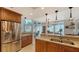 Modern kitchen with stainless steel appliances and wood cabinets at 1904 Harbourside Dr # 204, Longboat Key, FL 34228
