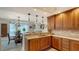 Kitchen with island, wood cabinets and granite countertops at 1904 Harbourside Dr # 204, Longboat Key, FL 34228