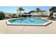 Hexagonal swimming pool with surrounding patio and palm trees at 1904 Harbourside Dr # 204, Longboat Key, FL 34228