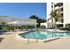 Octagonal pool with surrounding patio and lounge chairs at 1904 Harbourside Dr # 204, Longboat Key, FL 34228