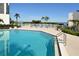 Inviting community pool with ample lounge chairs and waterfront views at 1904 Harbourside Dr # 204, Longboat Key, FL 34228