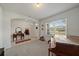 View of the front room with carpet, a piano, a rocking horse, and view to the front entry at 2819 Greenleaf Ter, Parrish, FL 34219