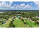Expansive aerial view of a golf course community featuring lush greenery, serene ponds, and beautiful homes at 2960 Sandringham Pl, Sarasota, FL 34235