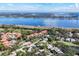 Scenic aerial view of a community with homes nestled among trees, near a lake at 2960 Sandringham Pl, Sarasota, FL 34235