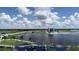 Wide aerial view showcases the lake and building with the surrounding green landscape at 2960 Sandringham Pl, Sarasota, FL 34235