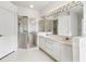 Well-lit bathroom with glass enclosed shower, double sinks, and vanity at 2960 Sandringham Pl, Sarasota, FL 34235