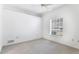 Bright and airy bedroom with a large window and neutral carpeting at 2960 Sandringham Pl, Sarasota, FL 34235