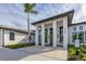 Modern building exterior featuring tall columns and large windows, providing a bright and welcoming entrance at 2960 Sandringham Pl, Sarasota, FL 34235