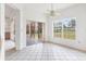 Bright dining area featuring tile flooring, a ceiling fan, and sliding glass doors to the lanai at 2960 Sandringham Pl, Sarasota, FL 34235